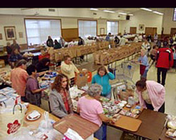 Image of LOW-INCOME RESIDENTS MOVE THROUGH GROCERY LINE AT CALIFORNIA PANTRY - Low-income clients move through the grocery line at St. Margaret Mary Alacocque Church food pantry in the Los Angeles suburb of Lomita. The food tables in the parish hall are staffed by church volunteers who prepare all week for the event, which provide s groceries for some 250 families. St. Margaret Mary is a largely middle-class, ethnically diverse parish amid neighborhoods of tidy homes. Over its 70 years, it has developed a reputation for aggressively serving the poor. (CNS photo/Bill Stephens) 