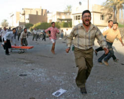 Image of Iraqis run through the streets of Baghdad after bombs exploded in five Catholic churches Aug. 1. The Islamic-Catholic Liaison Committee condemned terrorist violence. At least 11 people died and more than 50 were injured when terrorists made coordinated attacks in Baghdad and Mosul. (CNS photo from Reuters)