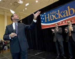 Image of Republican presidential hopeful, former Arkansas Gov. Mike Huckabee, tears up an IRS tax form while addressing students and supporters at the University of Maryland in College Park, Md., Saturday, Feb. 9, 2008. Behind Huckabee are, left to right, Maryland State Delegate Christopher Shanke, and Maryland State Delegate Tony McConkey.