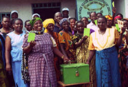 Image of Photo taken by CRS staff of a savings and lending group holding the locked box they use to store individual savings and group financial records.