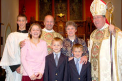Image of Fr. Dwight, his family and his Bishop.