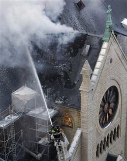 Image of Chicago firefighters work in freezing temperatures on a extra-alarm fire at the Holy Name Cathedral, the seat of Cardinal Francis George, in Chicago, Wednesday, Feb. 4, 2009.