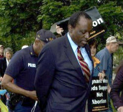 Image of Dr. Keyes was one of the first arrested after one of the officers demanded they leave campus.The encounter became more intense when police began to remove Father Norman Weslin, a former Army Colonel who became a priest after his wife died in a tragic automobile accident. In his 80’s, Fr. Weslin is a familiar figure in the work of Pro-Life through Lambs of Christ.
