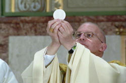 Image of (Bishop Martino at the elevation) The bishops have also asked the four institutions to provide information about their student health services to have assurance that no practice is occurring which would be in violation of Catholic teaching.