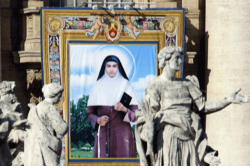 Image of A tapestry depicting St Alphonsa is seen near statues during her canonisation ceremony in St Peter's Square in 2008. (CNS photo/Alessandro Bianchi, Reuters) 