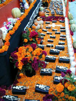 Image of Traditionally, families spend some time on All Souls Day around the altar, praying and telling anecdotes about the deceased. Poems and written tributes are also shared.