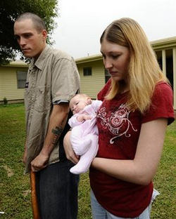 Image of Army Pfc. Joseph Foster, left, who was wounded during the Thursday's Fort Hood shooting, along with his wife Mandi and 6-month-old daughter Keilee, speaks to the media outside his home Sunday, Nov. 8, 2009 in Fort Hood, Texas.