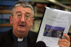 Image of Irish Bishop holding the Murphy Report at a Press Conference