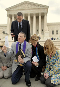 Image of Rev. Rob Schenck (kneeling) maintains a ministry office across the street from the US Supreme Court, one block from the U.S. Capitol and ten minutes from the White House. He is known on Capitol Hill where he ministers to those who serve in Government. He is a stalwart defender of children in the womb and a prophetic voice.
