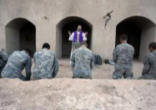 Image of U.S. soldiers of the 1st Battalion, 17th Infantry Regiment, 5th Brigade, 2nd Infantry Division, kneel as Father Carl Subler, a chaplain and captain, celebrates mass in Helmand province, southern Afghanistan, Sunday, Feb. 21, 2010. (AP photo)