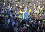 Image of Pope Benedict traveling through the enthusiastic crowd on the way to the altar for the first Mass in Scotland at the beginning of his visit to the UK.