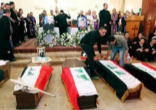 Image of Several of the coffins holding the bodies of Catholics killed, while attending Holy Mas, by Muslim extremists in Iraq