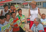 Image of Scott and Jean Adam hand out Bibles as part of their ministry

