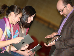 Image of Briar Cliff will provide Apple iPads to all first-year, full-time students, beginning with the fall 2011 semester. Test driving the iPads are Sam Shanks, BCU's division chairperson of general education and assistant professor of theatre, and incoming freshmen Erica LoVan, North High School, left, and Brittany Copple, Peacemakers Academy, right. 