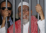 Image of The now-convicted terrorist Abu Bakar Bashir behind bars.