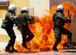 Image of Police under assault from protesters opposed to the latest round of austerity measures imposed by Parliament. 