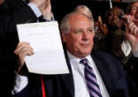 Image of Illinois Governor Pat Quinn holds up the signed civil unions bill 