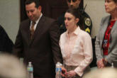 Image of Casey Anthony accompanied by counsel leaving the courtroom after the verdict was read