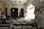 Image of Iraqis survey bomb damage done in today's attacks. 