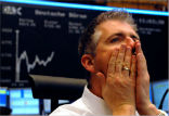 Image of Investors watch as the markets tumble on a series of bad economic reports and forecasts.