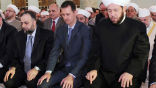 Image of Syrian president al-Assad is seen praying in a mosque at the start of  Eid al-Fitr.