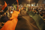 Image of Residents of Tripoli celebrate the downfall of Moamar Gadhafi's regime. 