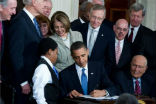 Image of President Obama signs the Affordable Care Act into law in this file photo.
