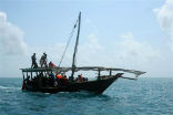 Image of A boat brings survivors ashore on Saturday. Some were rescued after seven hours at sea.
