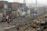 Image of Residents survey the rubble following Friday's quake.