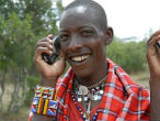 Image of This Masai man has plenty of reason to smile. Cell phones are making his world a better place.