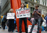Image of Protesters hold signs and text each other as Occupy Wall Street continues.