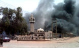 Image of Buildings burn as a result of Friday's violence.