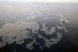 Image of This Nov. 18 photo shows efforts to contain the spill.