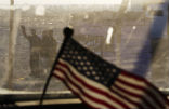 Image of Iraqis wave goodbye as the American armored vehicle departs.