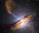 Image of Galaxy Centaurus A in this composite image. Note the blue jet of material being shot out of the galaxy's core. The jet is being caused by a supermassive black hole. The jet is longer than the galaxy itself; it is one way scientists can observe black holes without seeing them directly. 