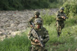 Image of Colombian soldiers on patrol. Chilling reports allege that some of their comrades have been committing gross, systematic atrocities for personal gain. 