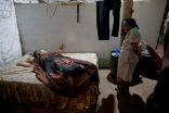 Image of The deceased body of Jesus Flores, 51, lies in bed before his mother. Flores died of CKD on January 19th and is one of thousands across the region who will meet the same fate this year alone. 