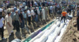 Image of Civilians buried in a mass grave following the Houla massacre. Almost half were children. 
