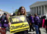 Image of An Obama supporter holds a sign at a pro-Obamacare rally earlier in the year. 
