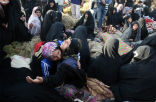 Image of Victims of the quake try to comfort one another amid the grief and the aftershocks. 