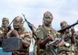 Image of Boko Harem members displaying their weapons