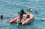 Image of Divers recover the lifeless body of a drowned girl. 