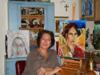 Image of Franco posing alongside several of her inspiring artworks. 