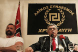 Image of Nikolaos Michaloliakos speaking at a conference for Golden Dawn.