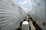 Image of Unused FEMA trailers sit idle along with displaced residents in New York. 