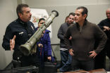 Image of Police Chief Charlie Beck with one of the rocket launchers collected during the buyback. 