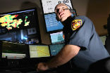 Image of An LAFD dispatcher handles a call. Photo, LA Times.