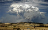 Image of A brush fire rages near Hobart, on Jan. 3, creating this spectacular site for rural residents. Such events are expected to be more common in the decades to come. 