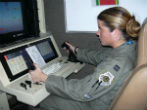 Image of Drones are now widely used in military operations. This image shows an Air Force Captain piloting a drone over Iraq in 2004.