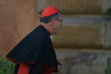 Image of Photographers caught a fleeting glimpse of Cardinal Mahony in Rome. 